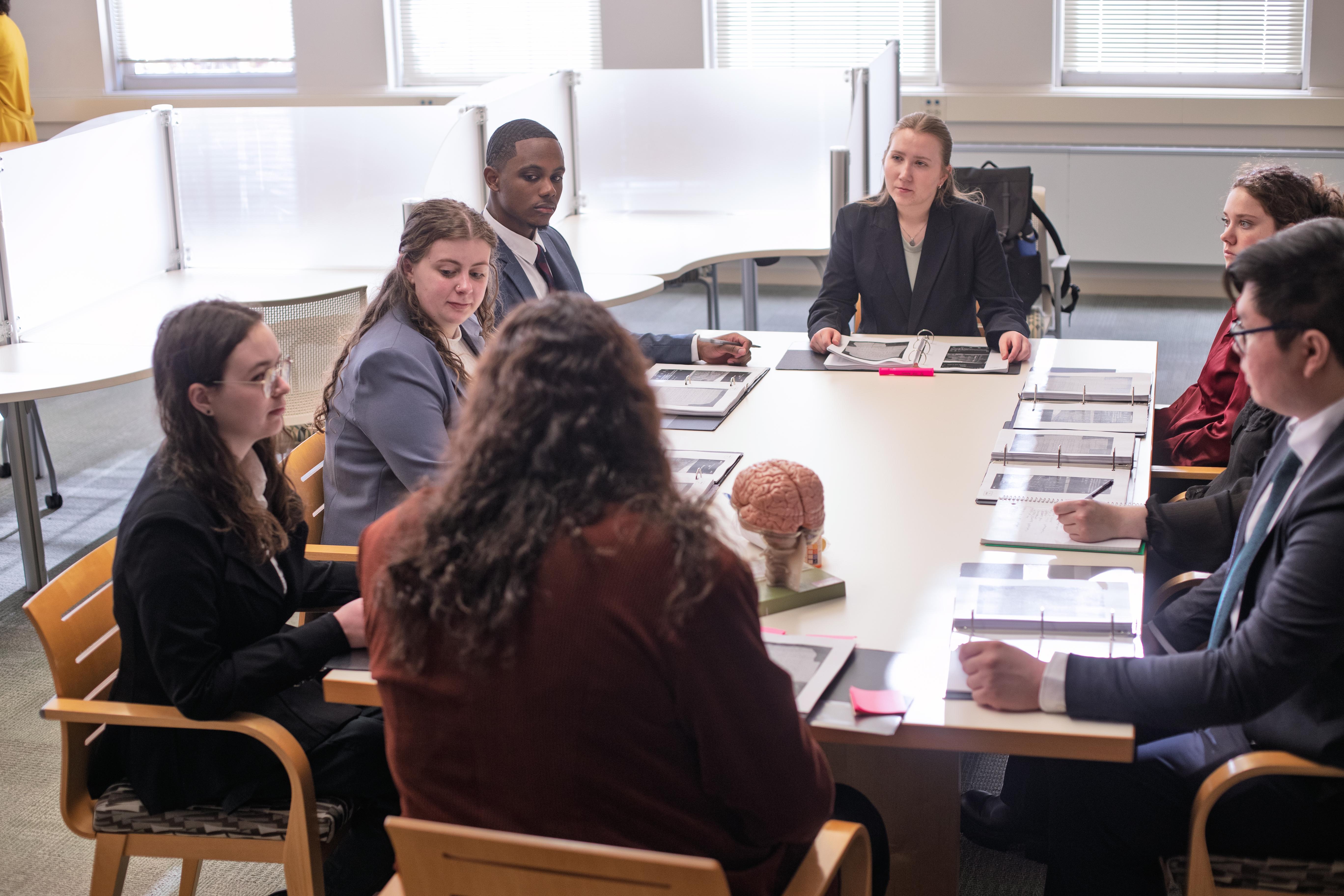 ACPHS Mock Trial Team members going over their roles at a dress rehearsal