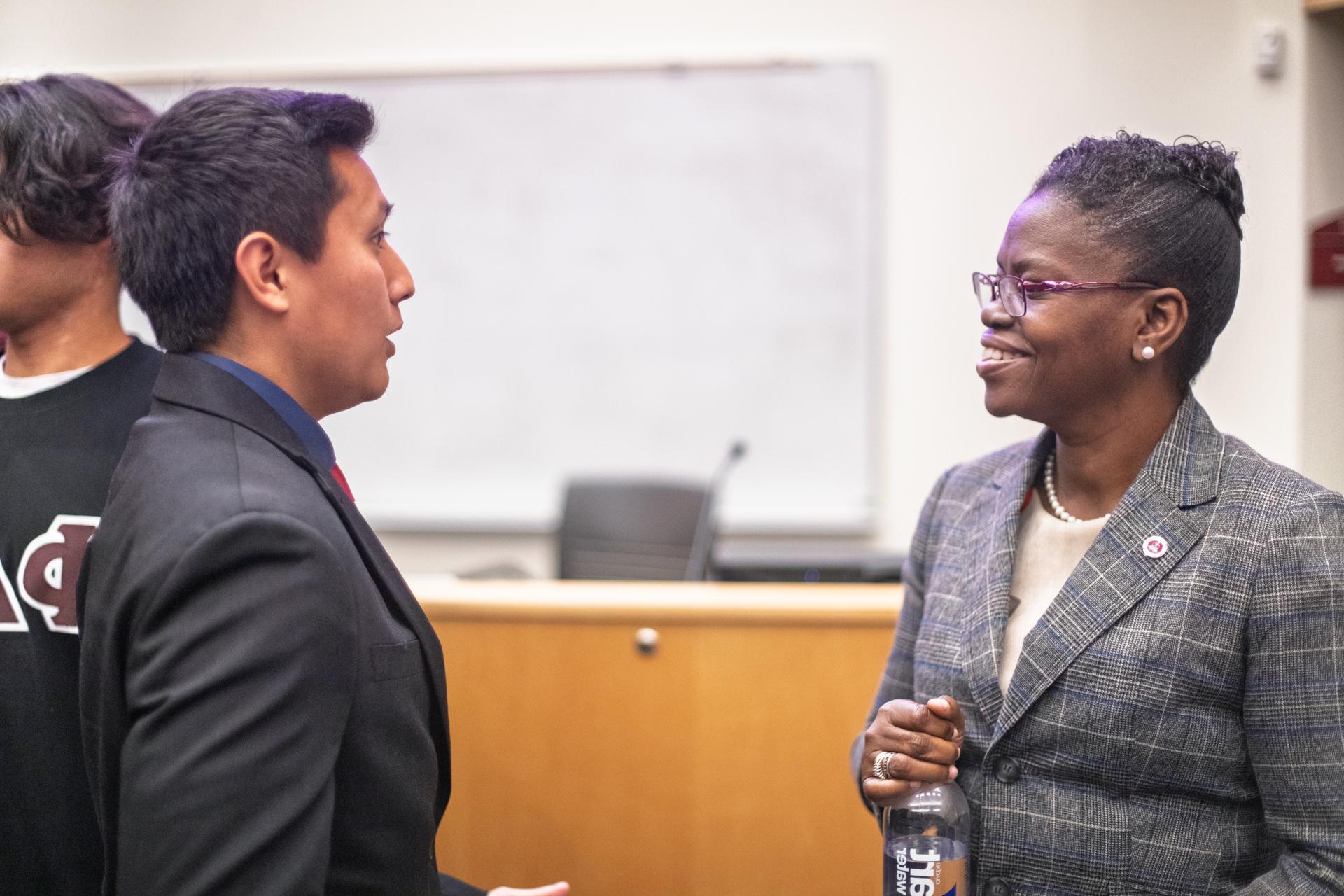 ACPHS President Toyin Tofade speaks with Phi Delta Chi member Alexander Campos at a leadership event. 